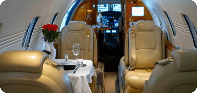 Private jet interior with dining setup